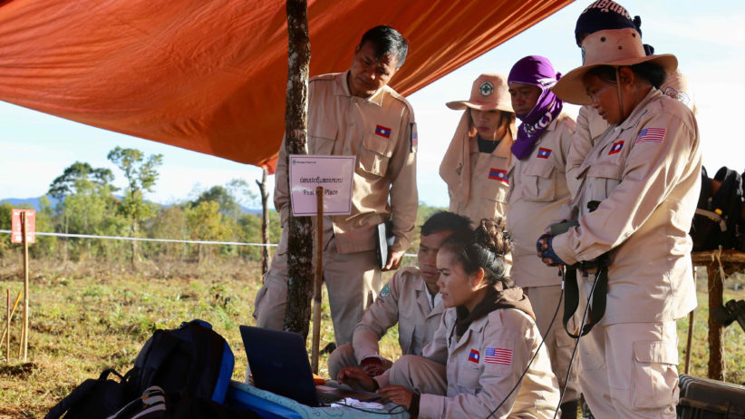 Quality Management Officer updating software for battle area searchers in Lao PDR