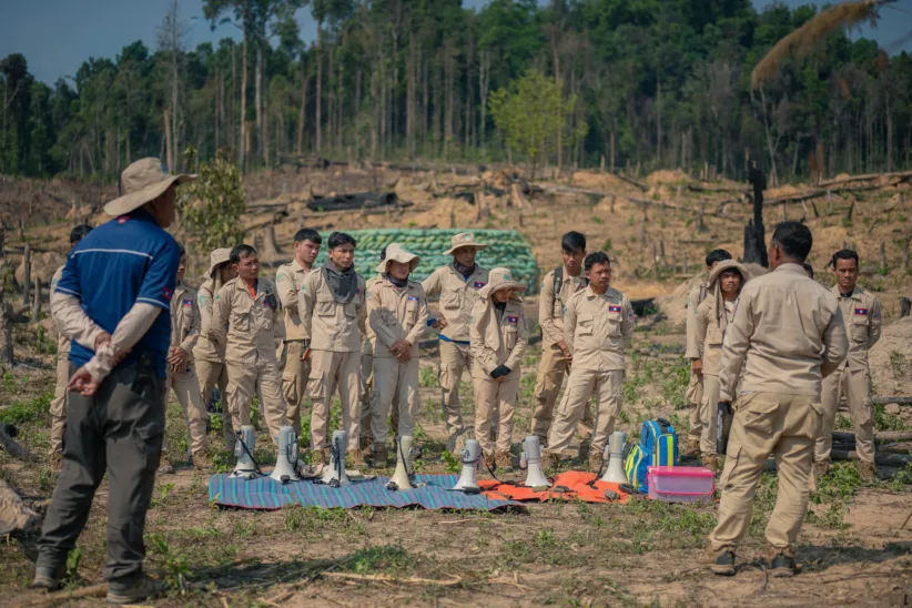 Mr. Jua Keovongsa, Team Leader, briefs his team members on the plan and assigns tasks prior to the demolition.